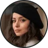 Portrait of a woman with long brown hair wearing a black beret and a neutral expression.