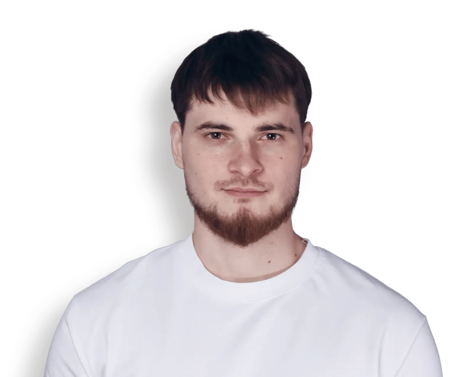 Portrait of a young man with short brown hair and a beard wearing a white shirt.