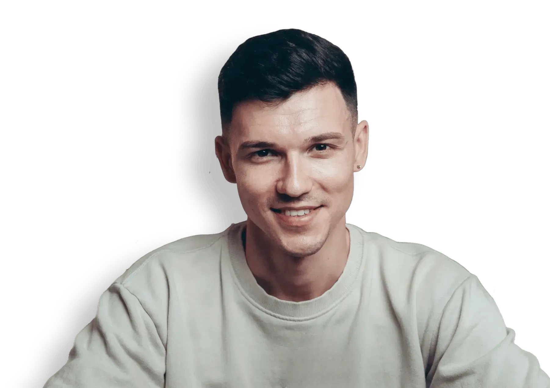 Smiling young man with short dark hair wearing a light grey sweatshirt.